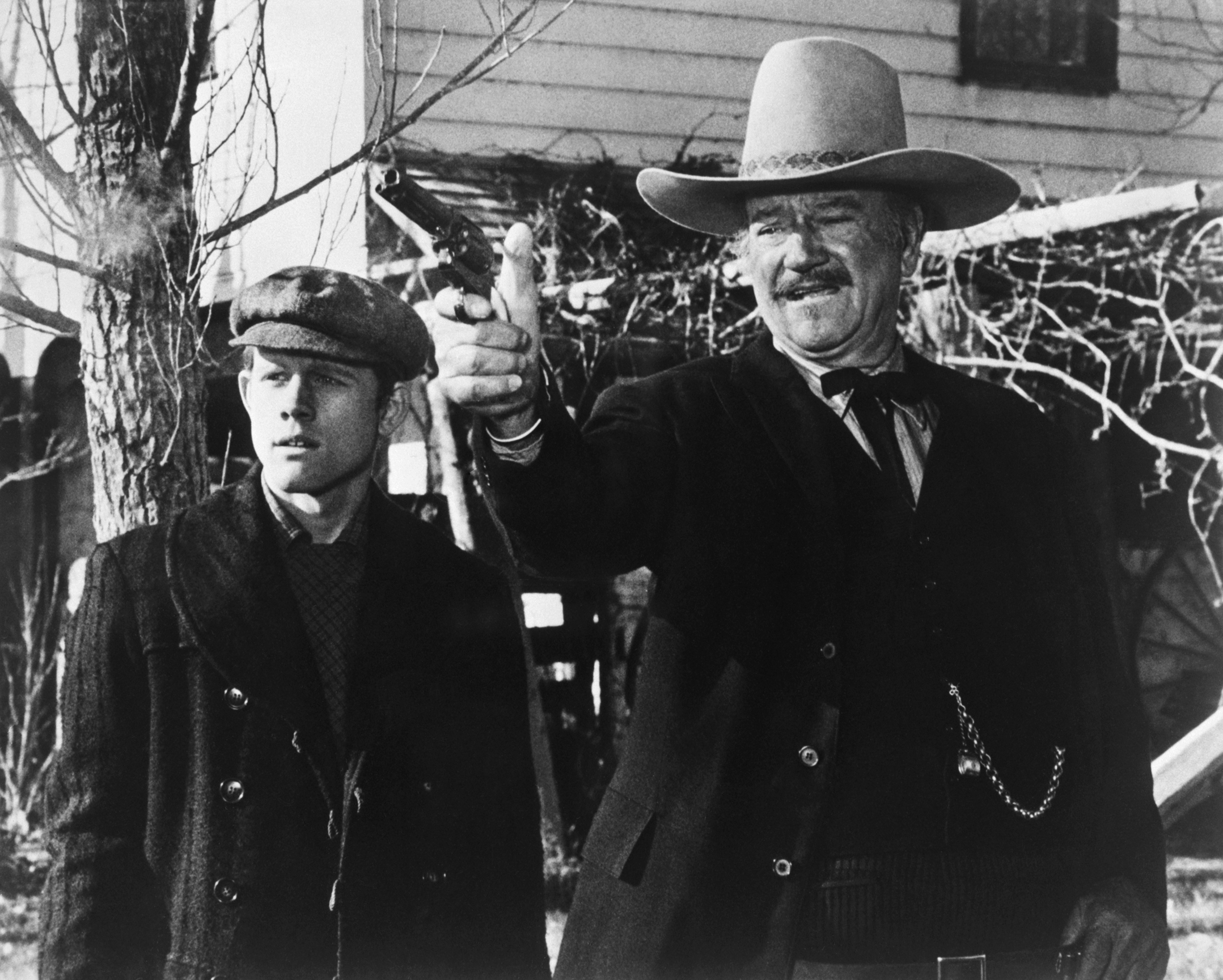 Ron Howard and John Wayne in a scene from the 1976 movie "The Shootist." | Source: Getty Images