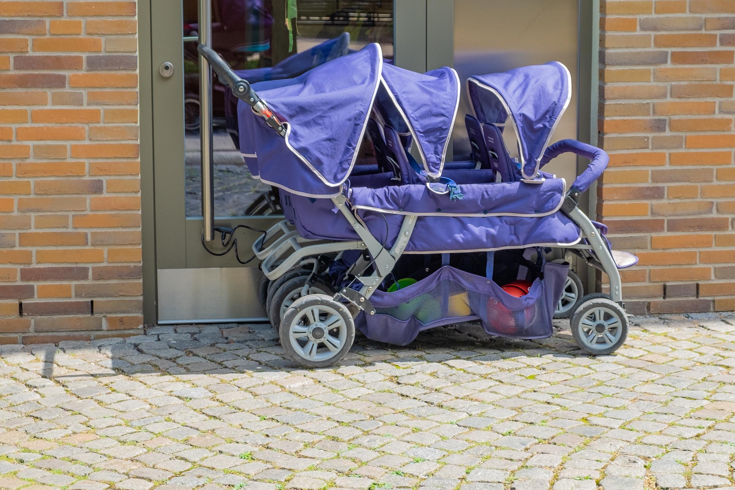Blue stroller for triplets | Source: Shutterstock