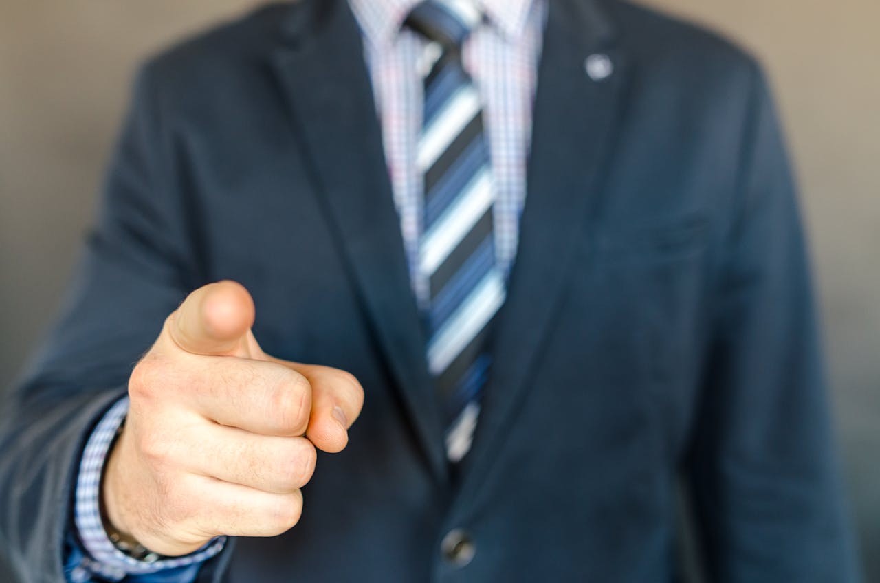 A man pointing an accusing finger at someone | Source: Pexels