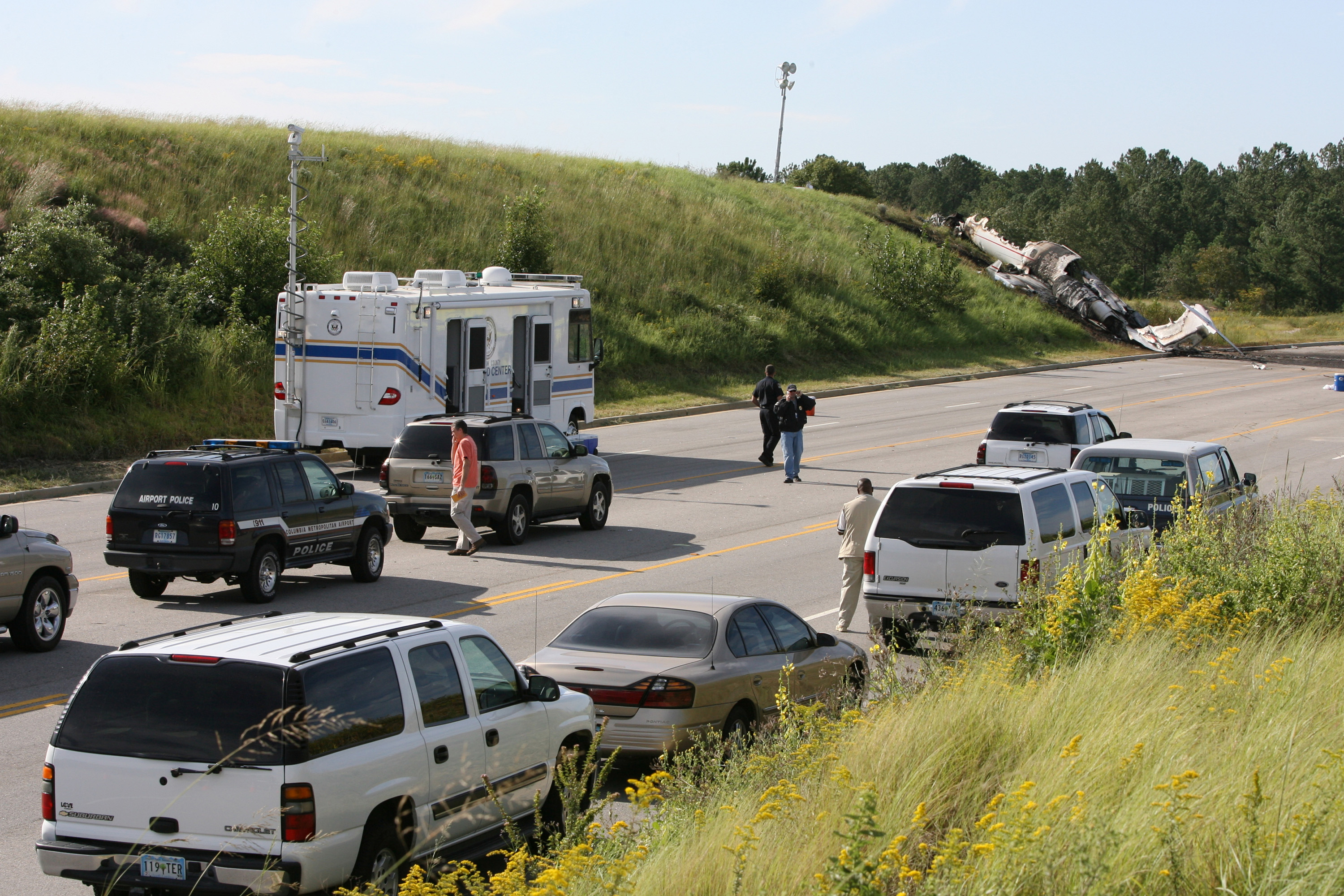 Officials wait to investigate a private jet crash carrying six people near the Columbia Airport in West Columbia, South Carolina, on Saturday, September 20, 2008. | Source: Getty Images