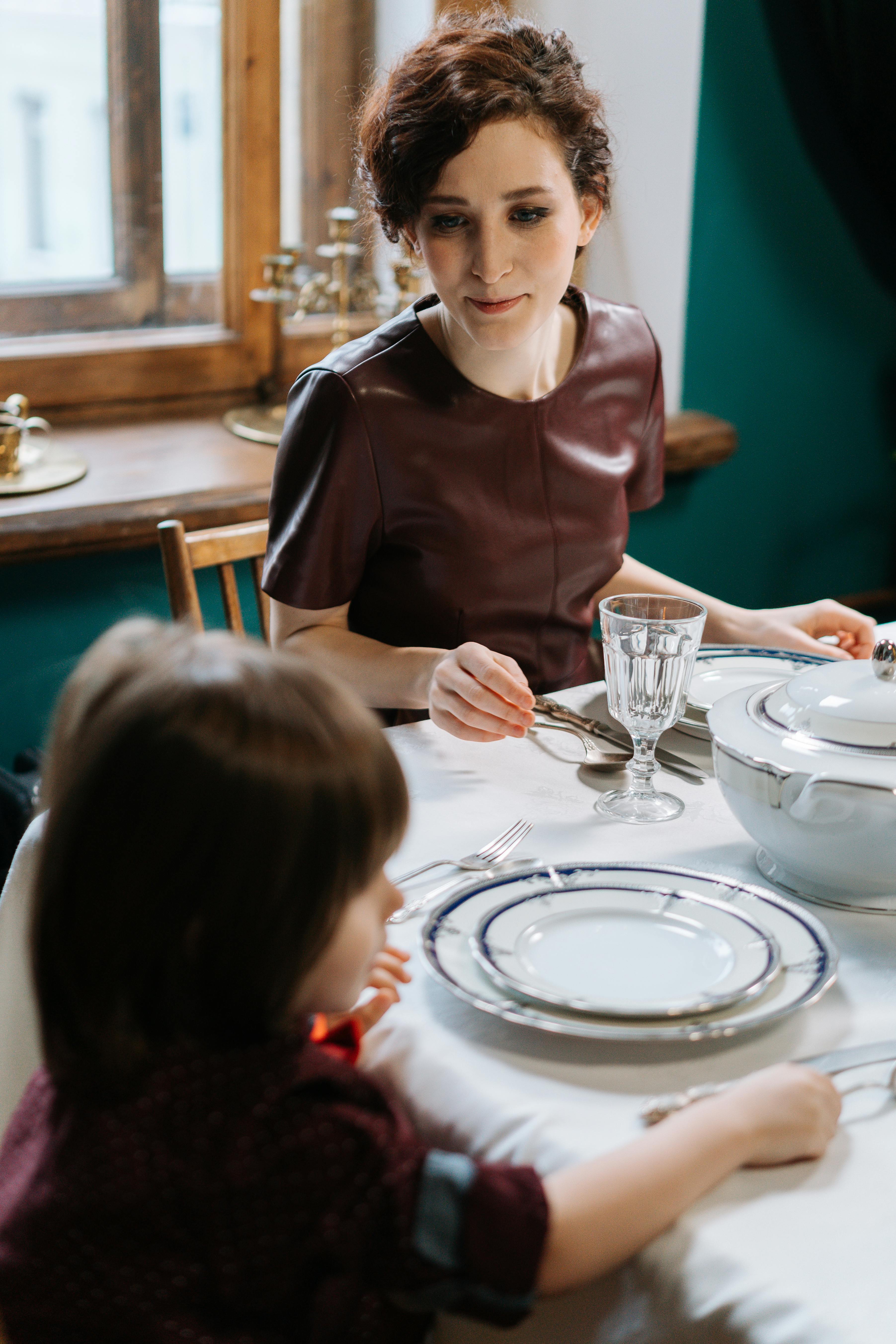 Nanny looking at a boy seated next to her | Source: Pexels
