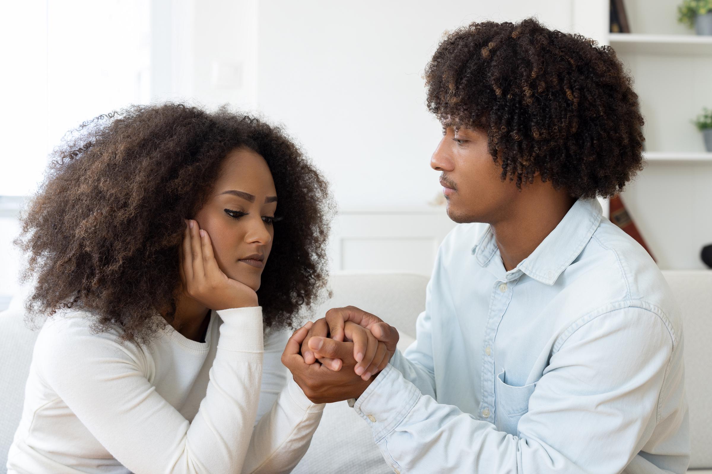 A young man apologizing to his partner | Source: Getty Images
