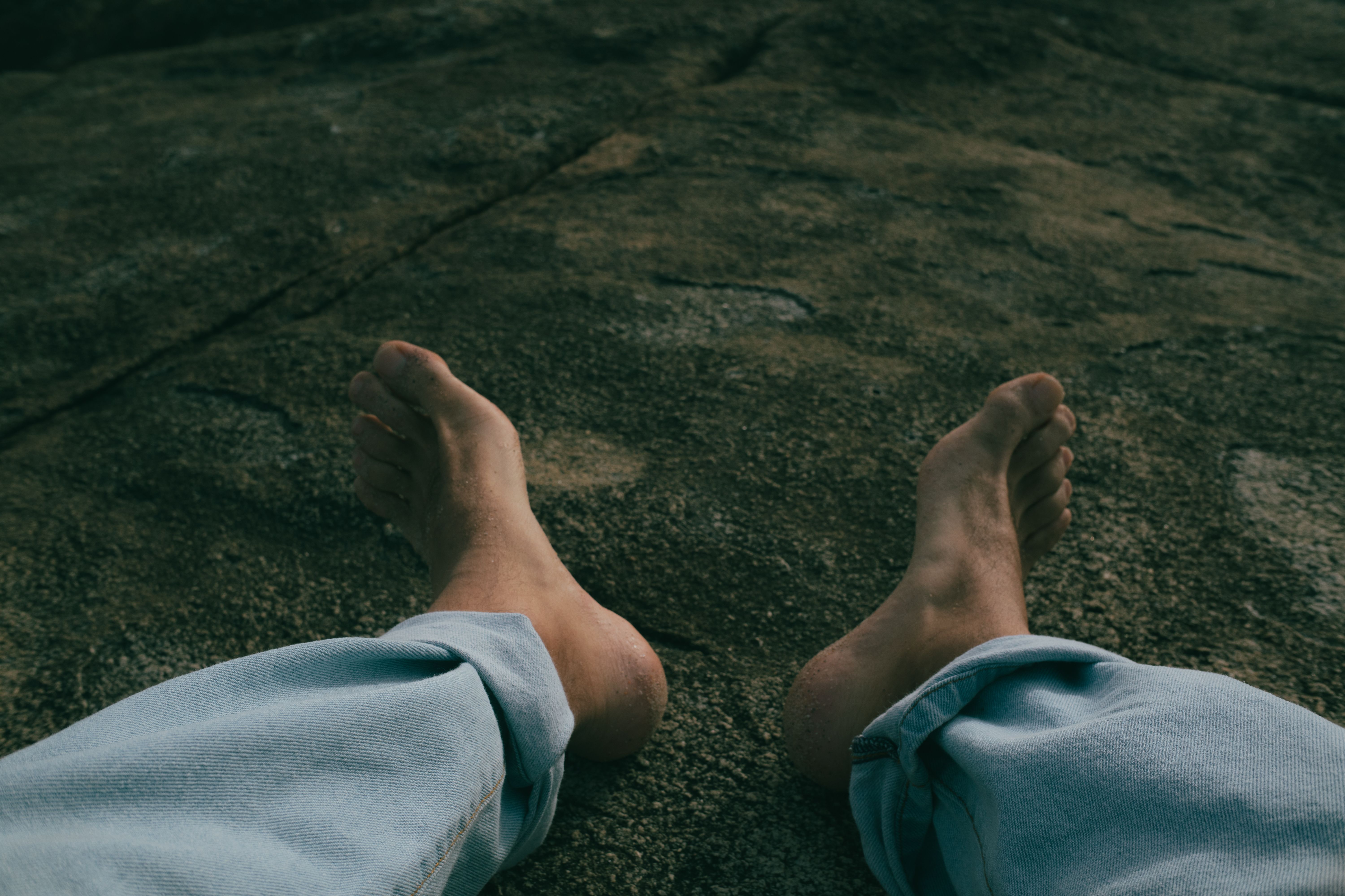 Bare feet on rocky terrain | Source: Pexels