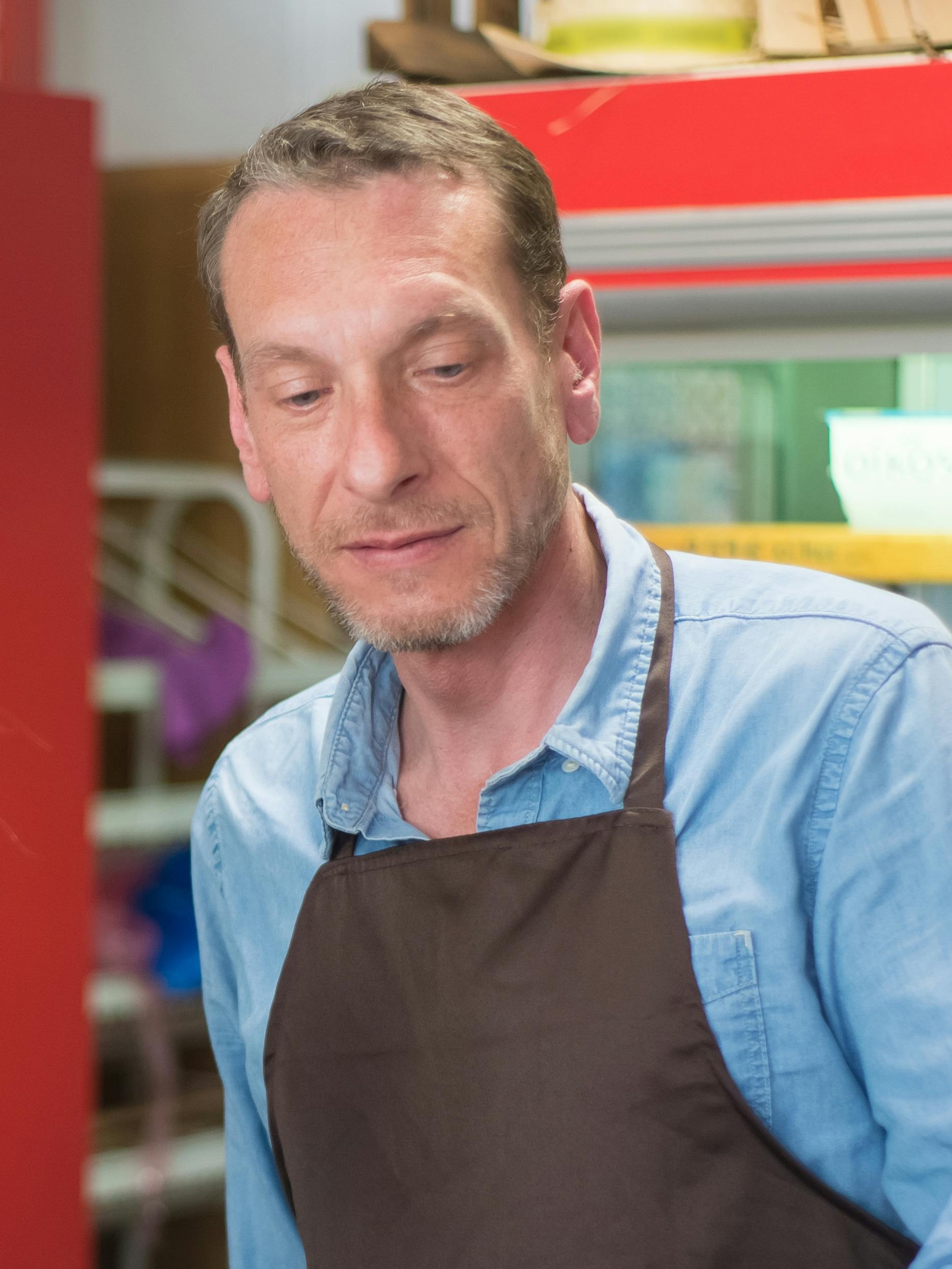 A store clerk in an apron, looking apprehensive | Source: Pexels