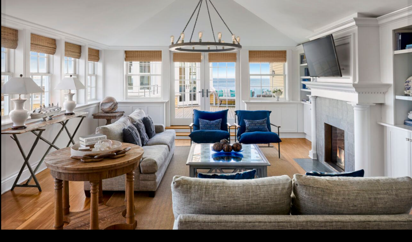 A spacious suite at Ocean House features coastal-inspired interiors, a fireplace, and sweeping views of the Atlantic. | Source: Facebook/Ocean House RI