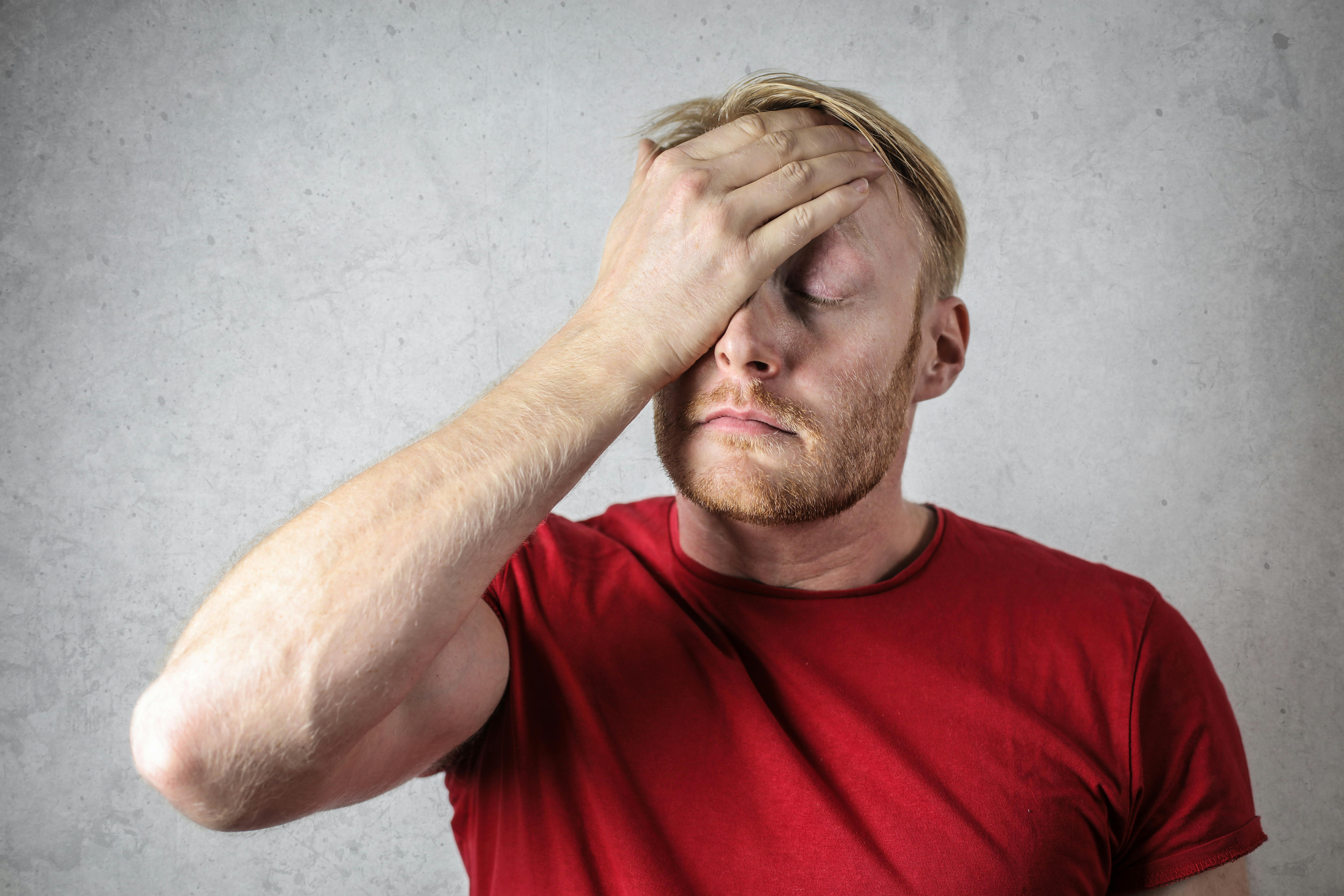 A man covering his face | Source: Pexels