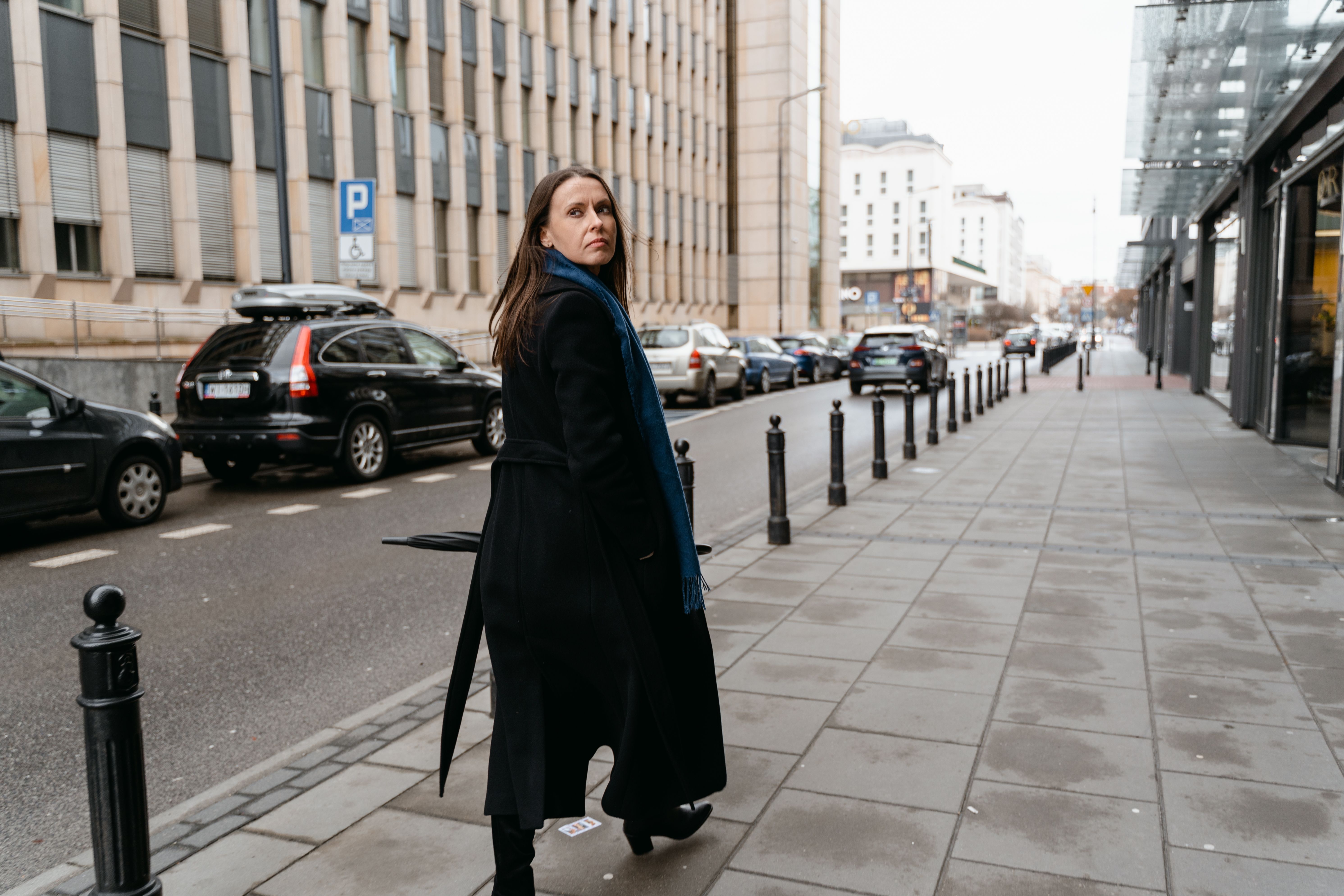 A woman in a long coat, walking on the street | Source: Pexels