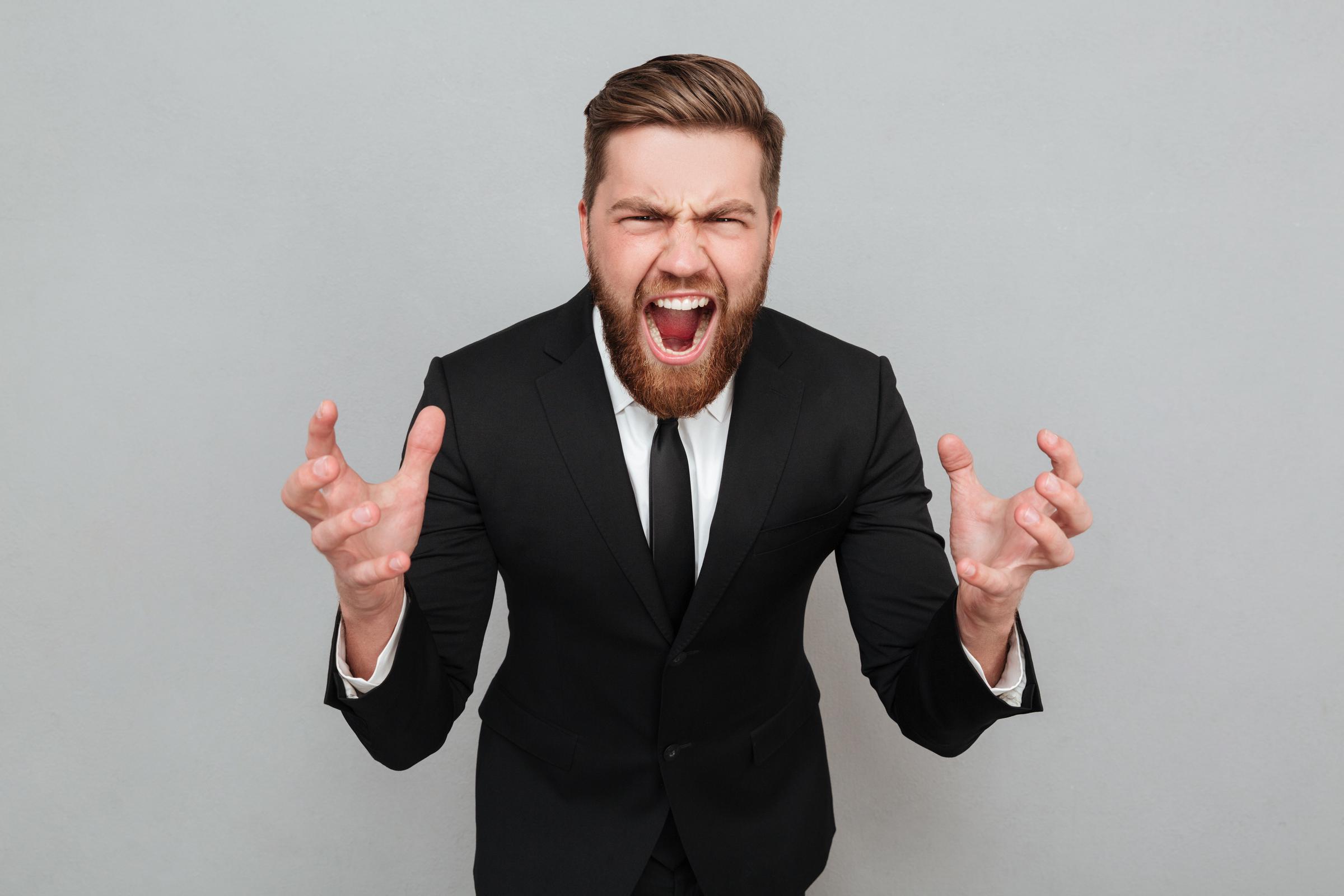 An angry man shouting | Source: Freepik