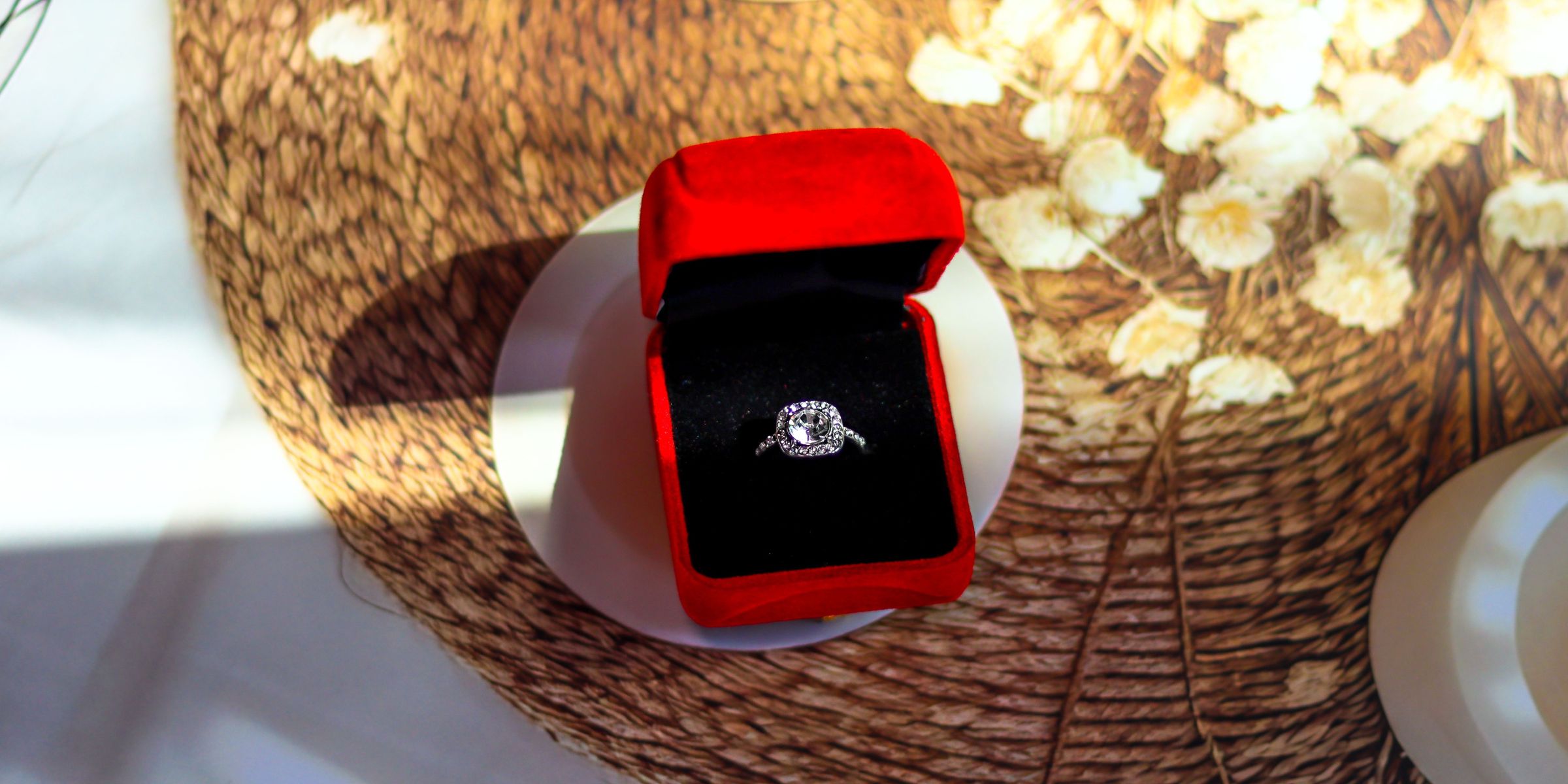 An engagement or wedding ring in a red velvet box | Source: Pexels
