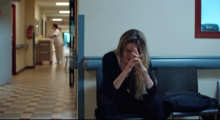 Angelina Jolie sits in a hospital hallway in a scene from the upcoming drama "Couture." | Source: YouTube/Vertical