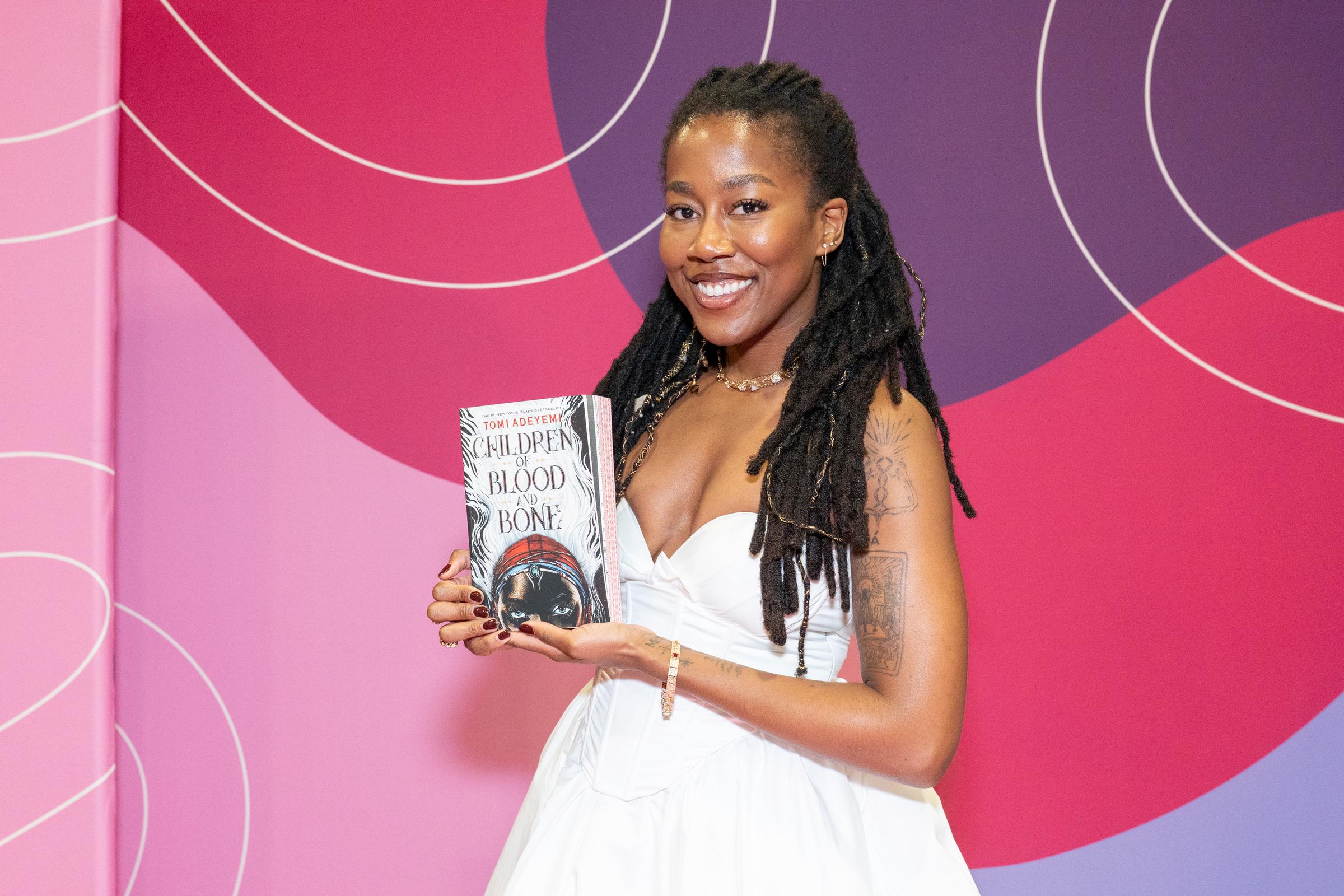 Tomi Adeyemi, #1 New York Times Best-Selling Author poses with her book, "Children of Blood and Bone" during the 2025 Pennsylvania Conference For Women at Pennsylvania Convention Center on September 25 in Philadelphia, Pennsylvania. | Source: Getty Images