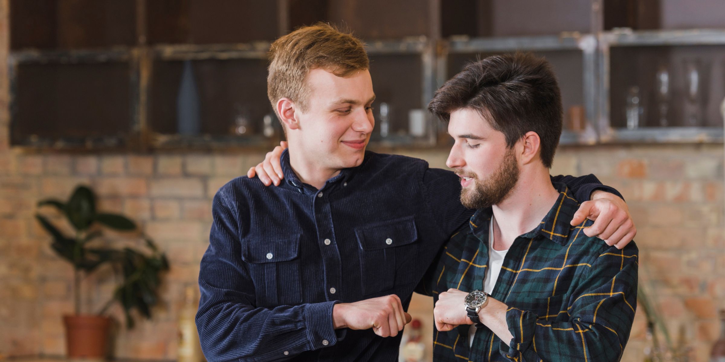 Two young men fist-bumping | Source: Magnific