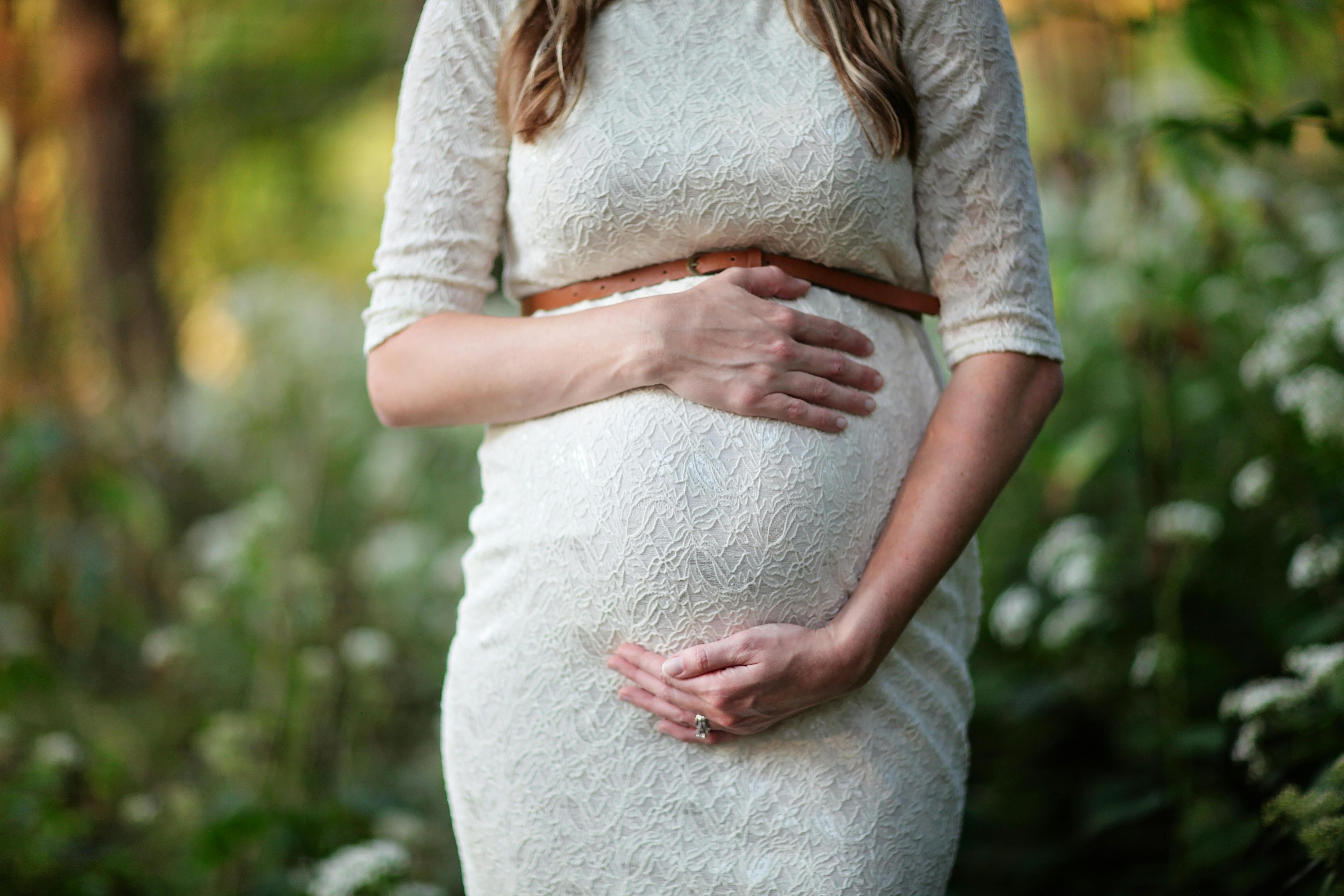 A pregnant woman holding her belly | Source: Pexels