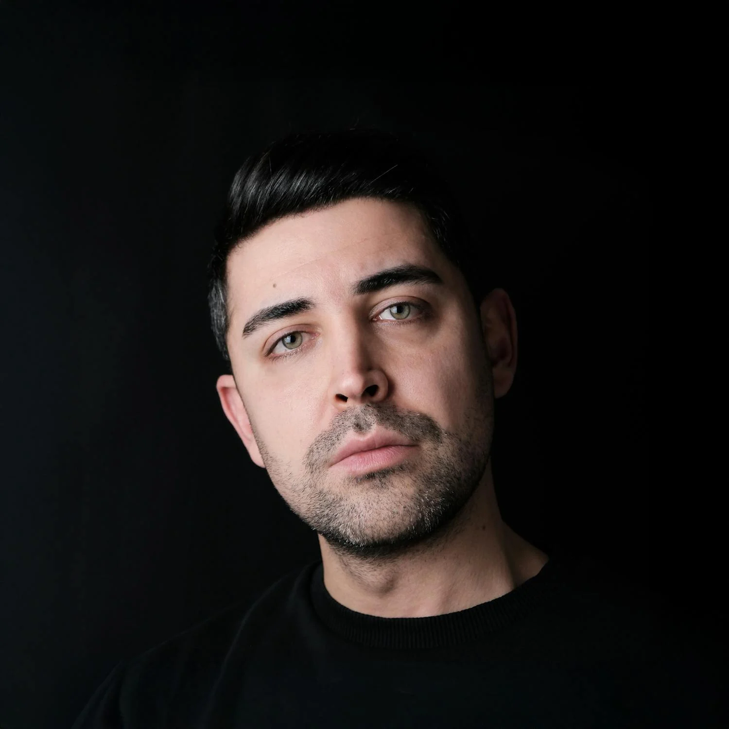 A serious man on a black backdrop | Source: Pexels
