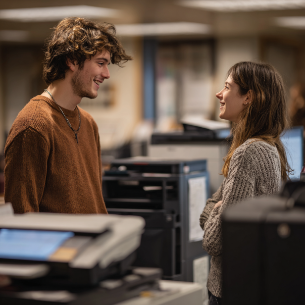 A man and a woman chatting at the library | Source: Midjourney