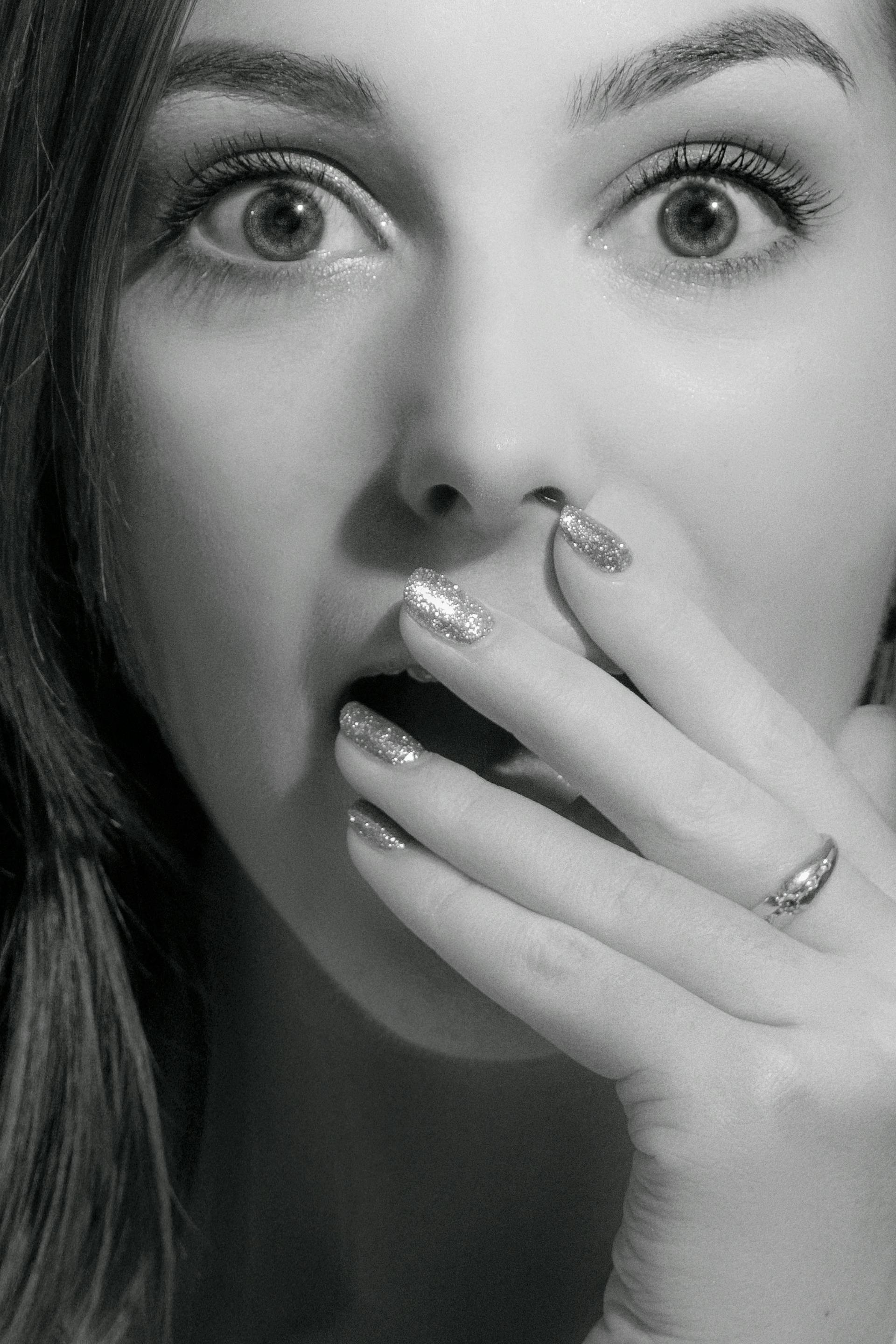 Grayscale shot of a startled woman | Source: Pexels