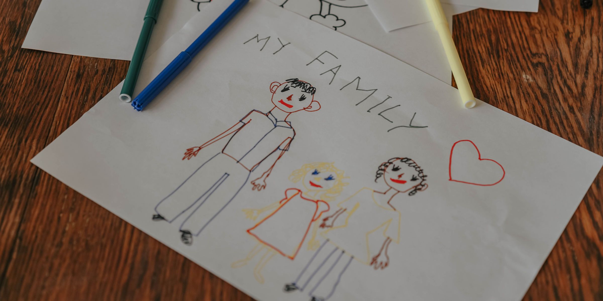 A child's family portrait drawing made with colored markers | Source: Pexels