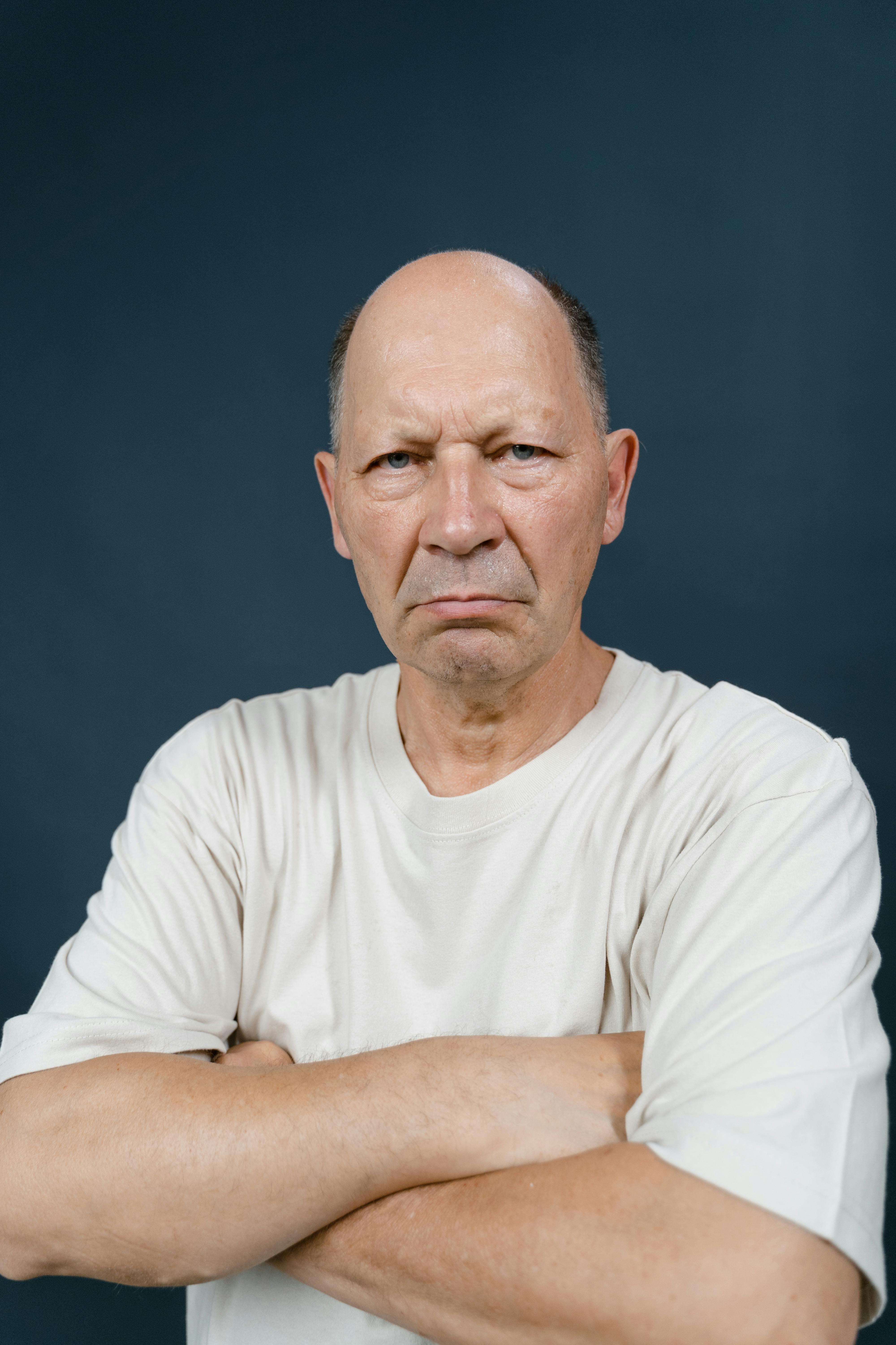 An unhappy man with his arms folded | Source: Pexels