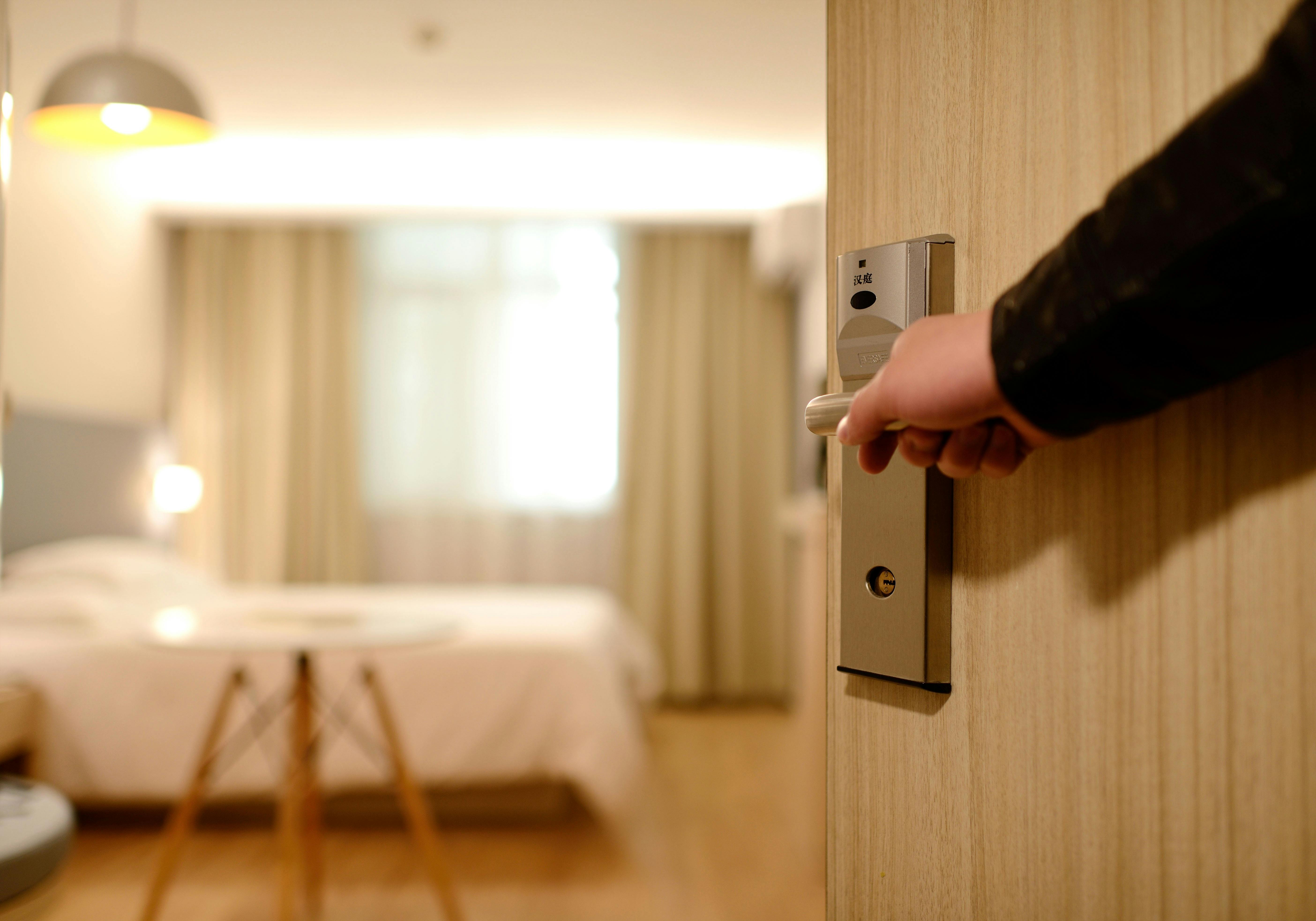 A man opening a bedroom door | Source: Pexels