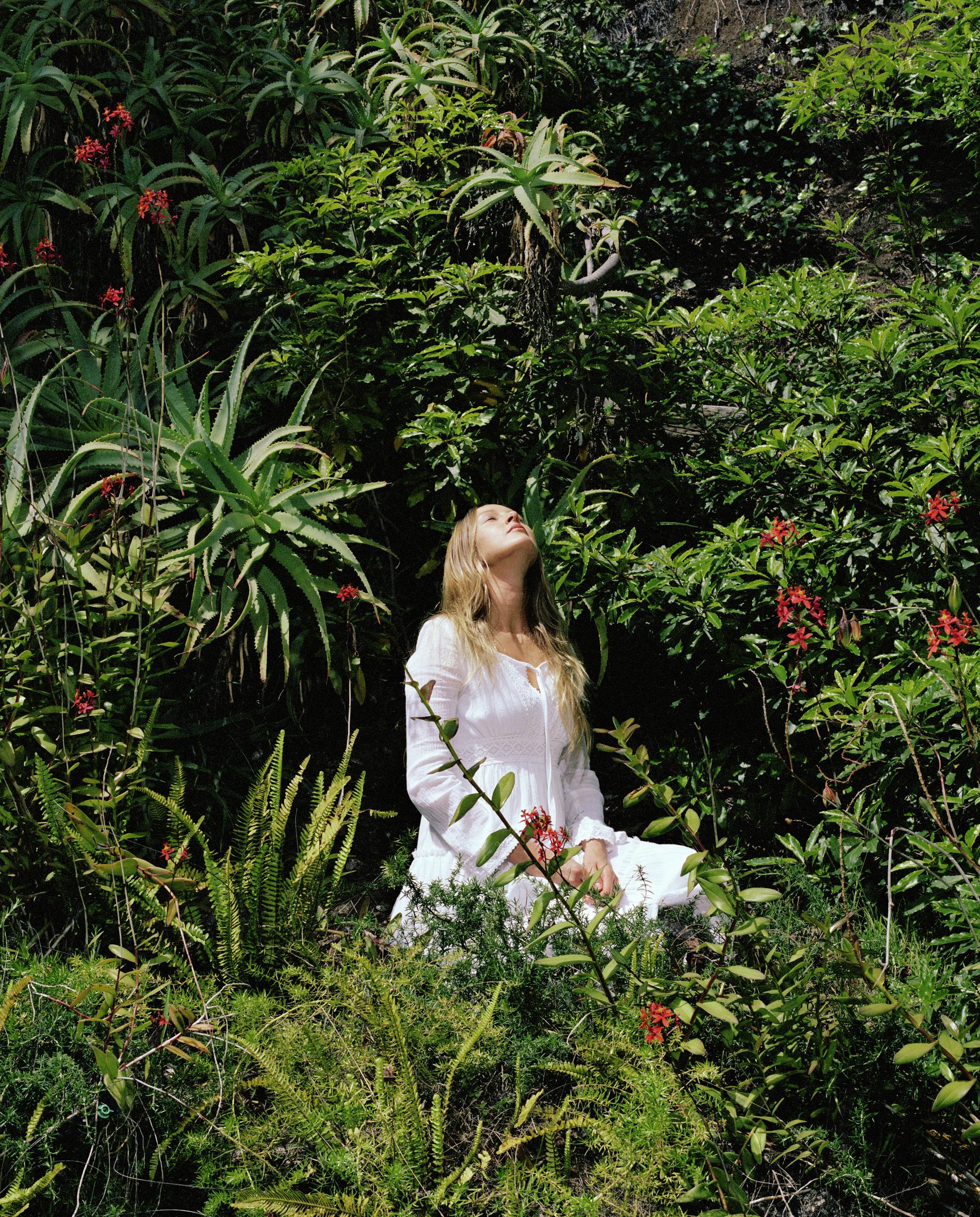 A woman sunbathing in a garden | Source: Getty Images