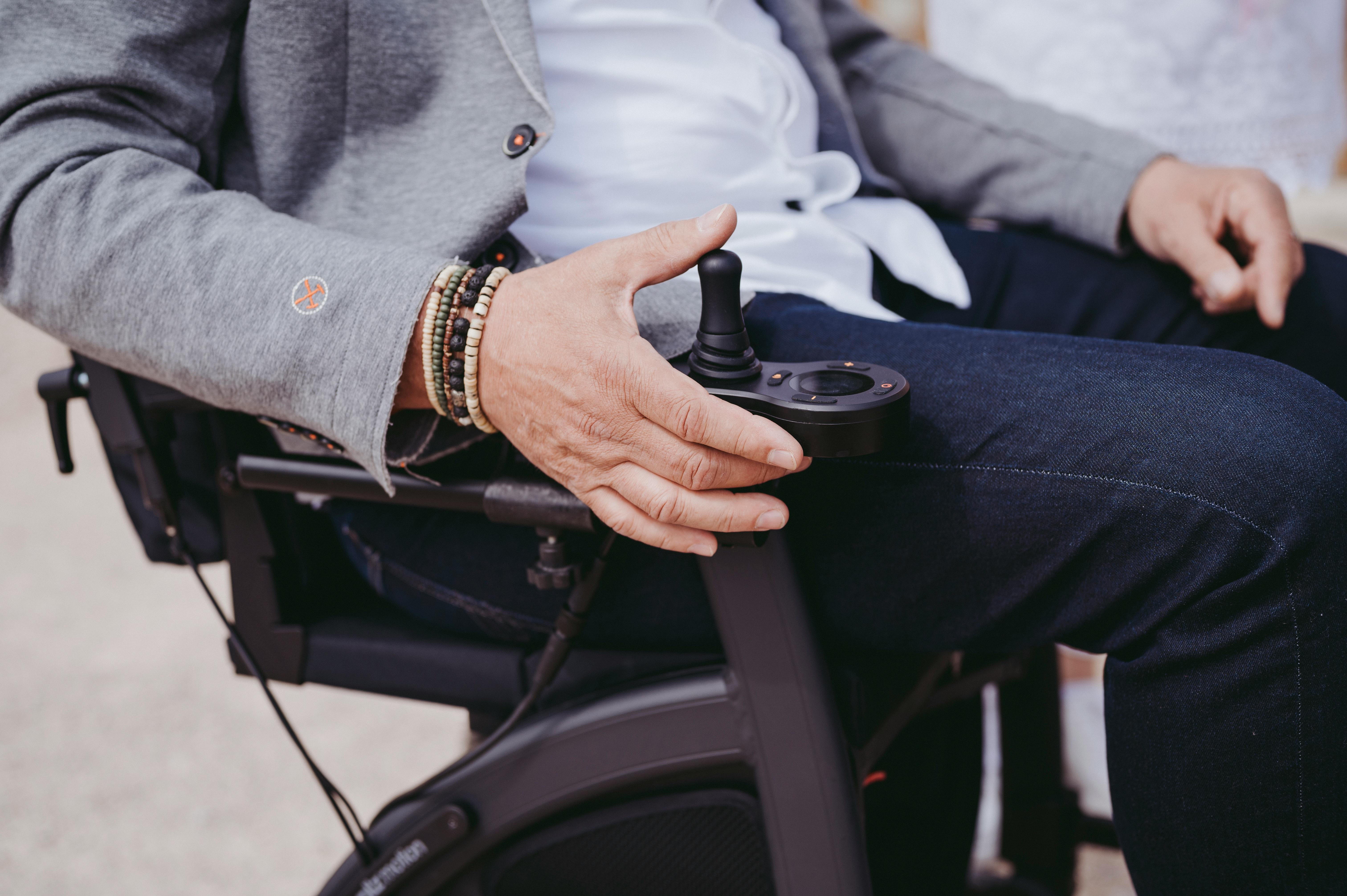 A wheelchair user activating the motion control | Source: Pexels